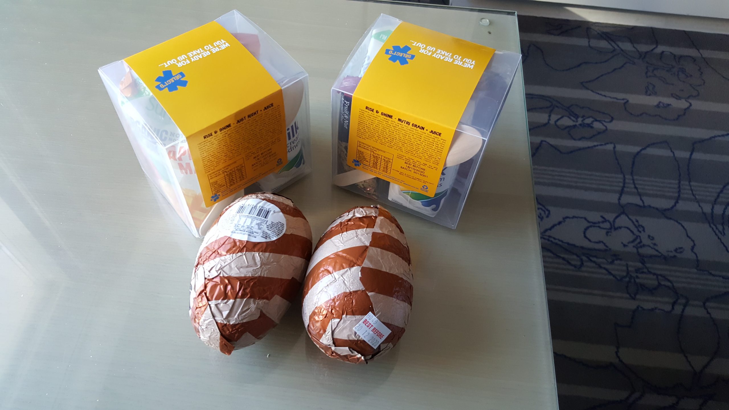 two Easter eggs with brown and white striped foil wrapping