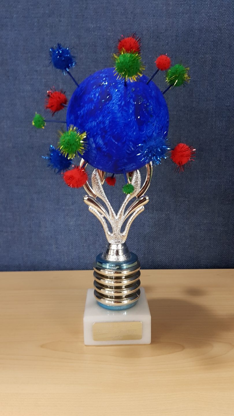 Handmade trophy with sparkly material balls on a silver base