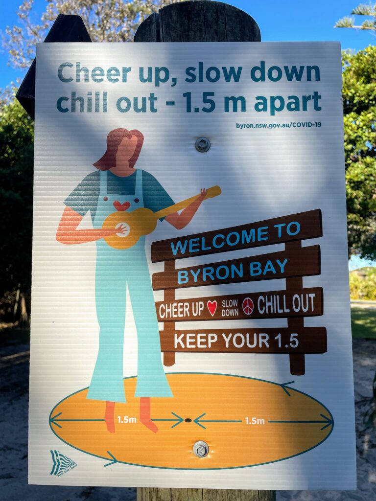 A poster that says 'cheer up, slow down, chill out - 1.5 m apart'