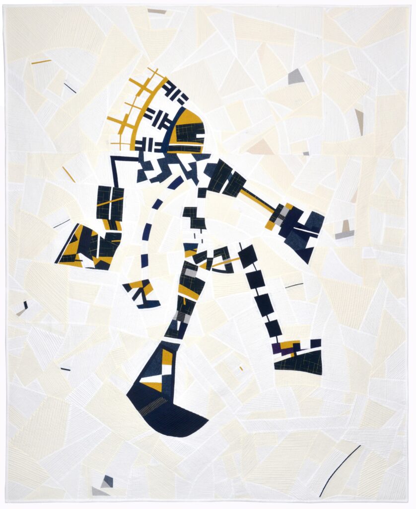 A quilt depicting an illustrated character made up of navy blue, white and gold square and rectangle shapes.