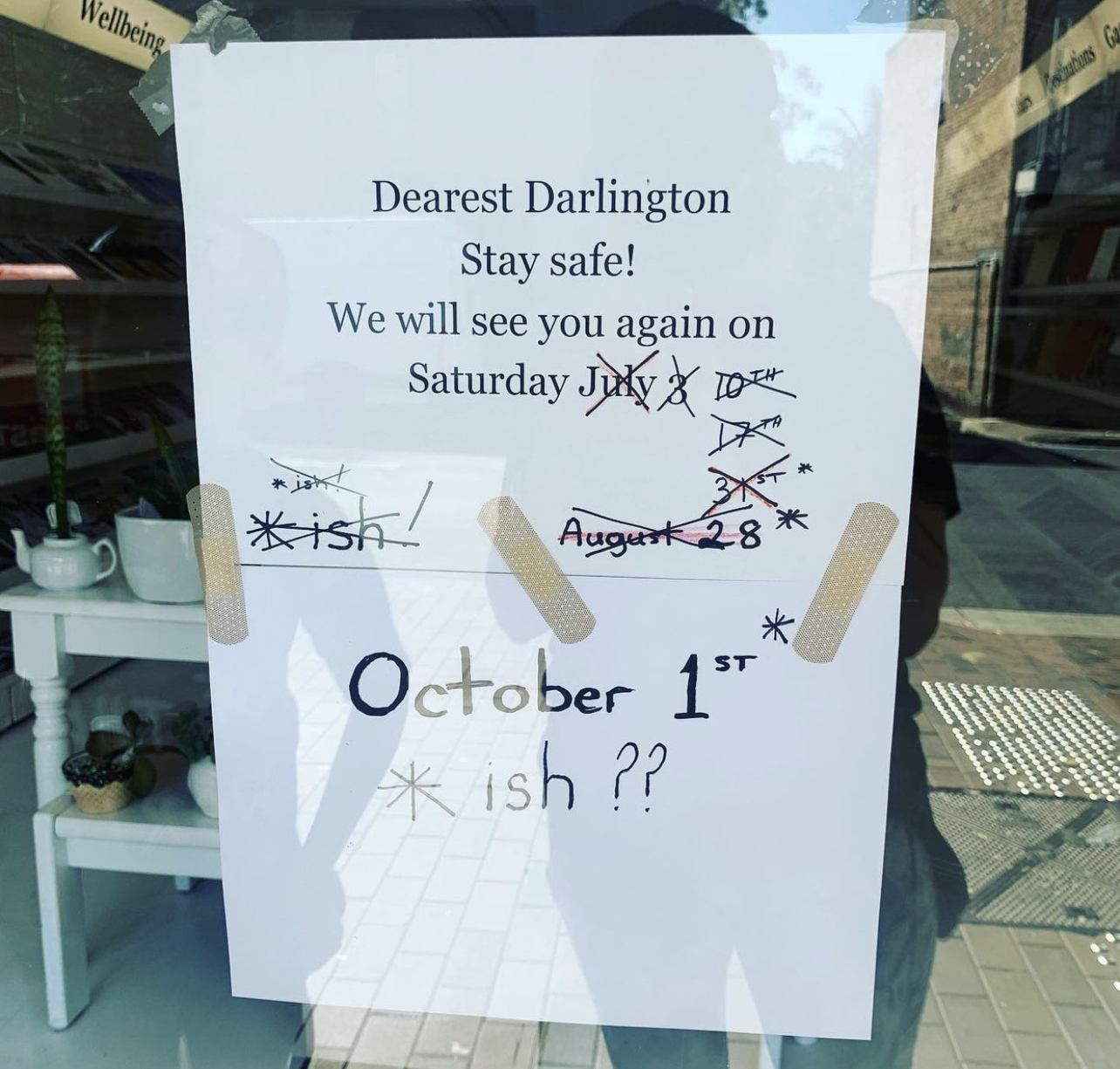 A white paper sign with black text that reads: Dearst Darlington, stay safe! We will see you again on Saturday - followed by 5 dates crossed out and finally the words 'October 1st ish'